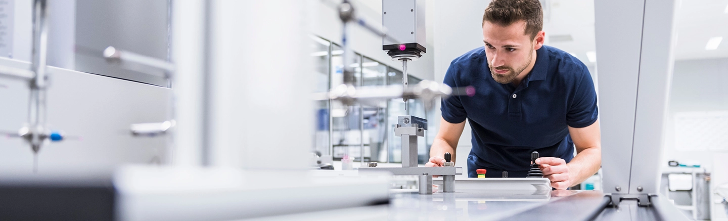 Man working with manufacturing dial 