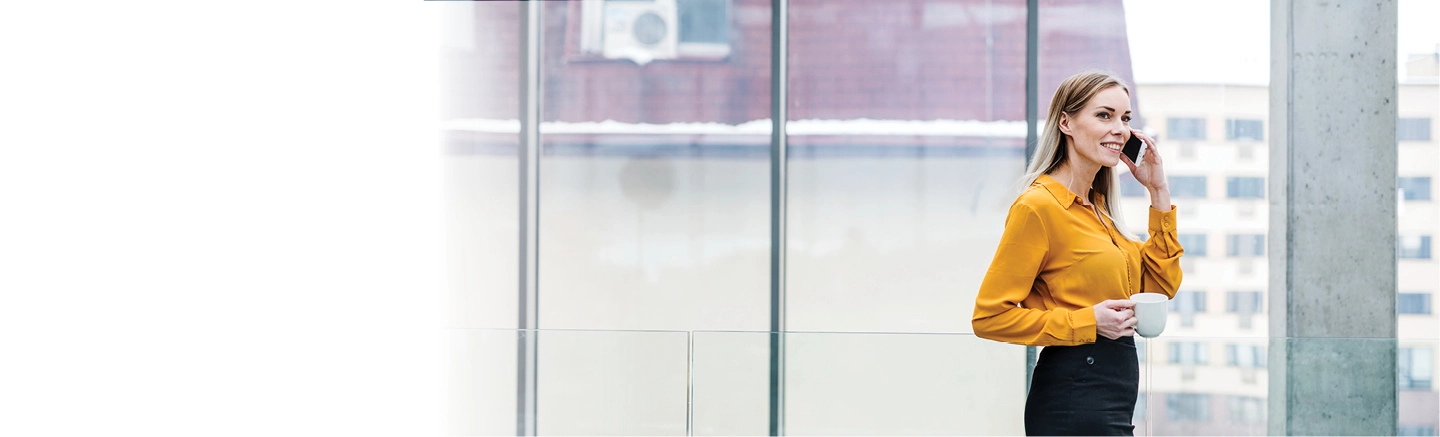 Blonde business woman on the phone in glass atrium