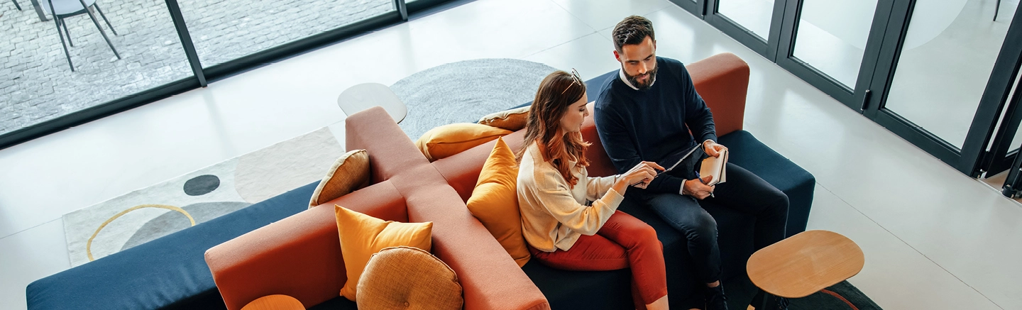 Man and woman holding tablet device