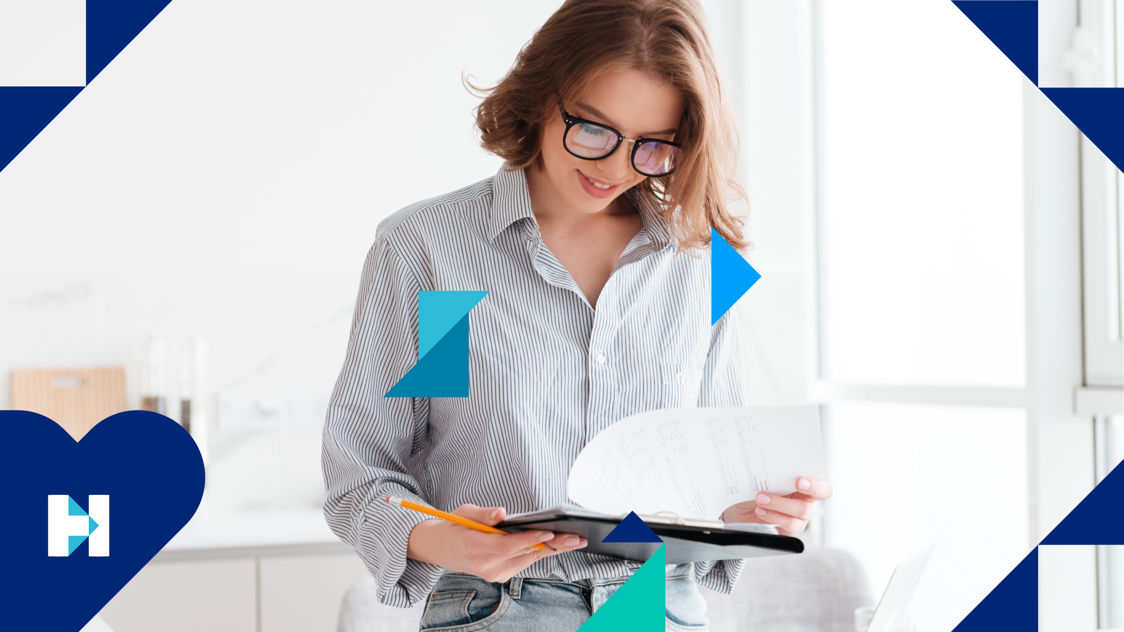 A woman wearing glasses and a blue striped shirt reviews her notes on a notepad, holding a pencil in her right hand,