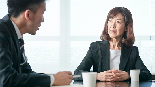 Man and woman at a table, talking