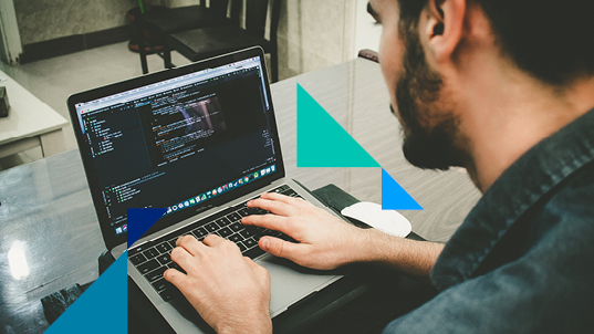 A man coding on his laptop