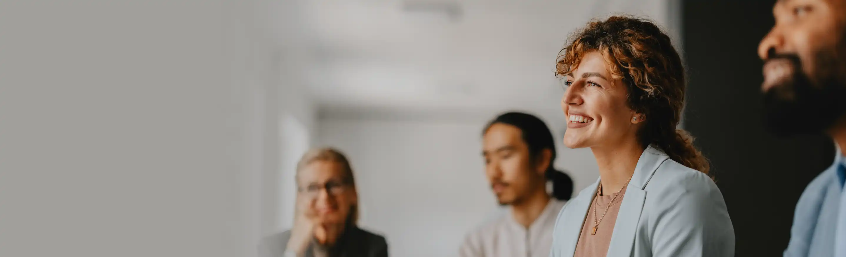 Business professionals attending a meeting in a modern office setting