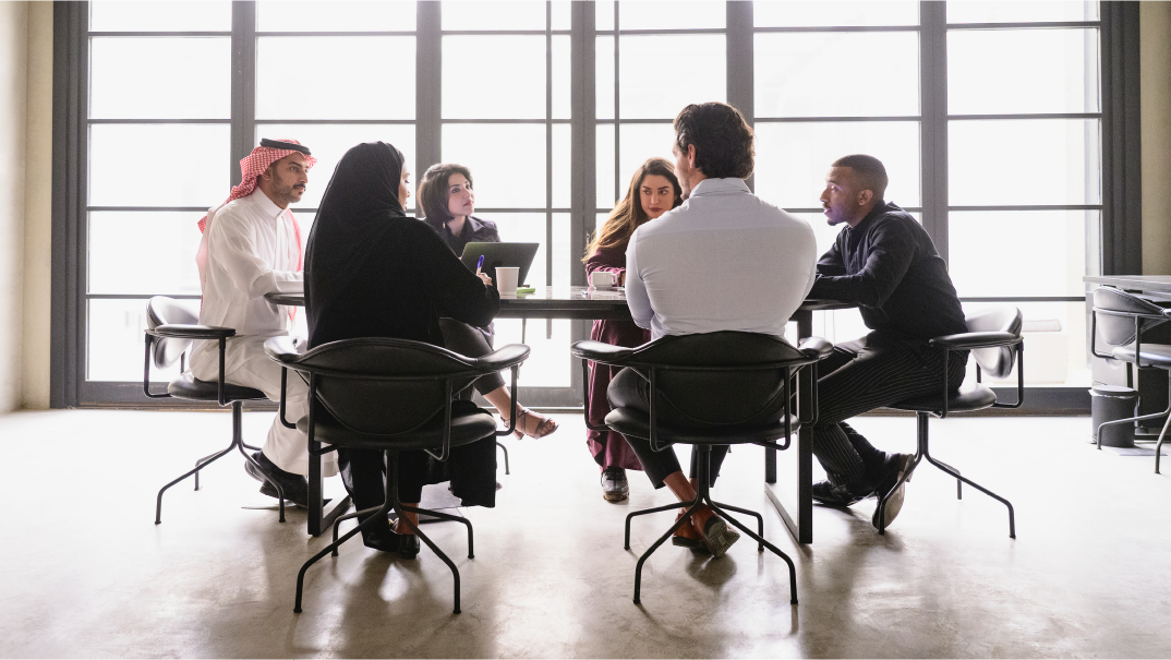 A group of people have an onboarding meeting in an office.